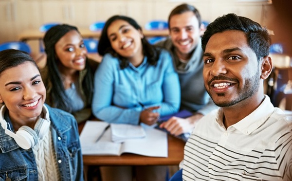 College is awesome. Cropped portrait of a group of young university students sitting in class